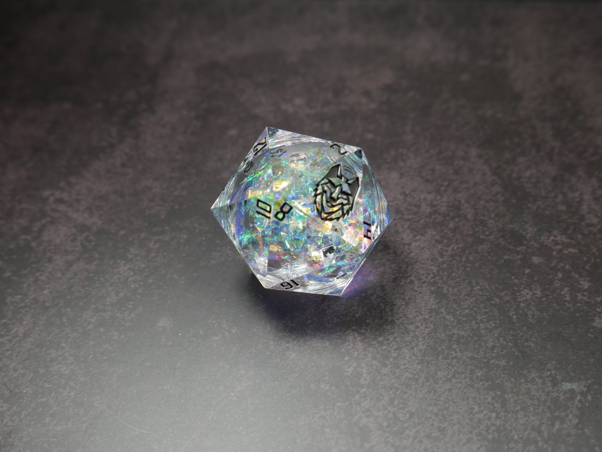 beautiful clear d20 die with bellum creations logo